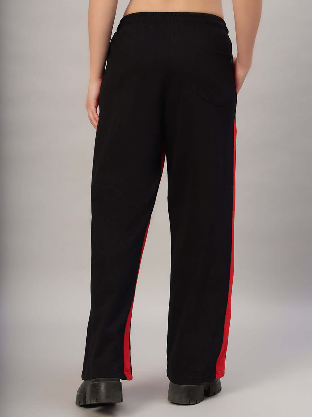 Rear view of women's black-red side seam baggy joggers, showcasing comfortable fit and stylish design.