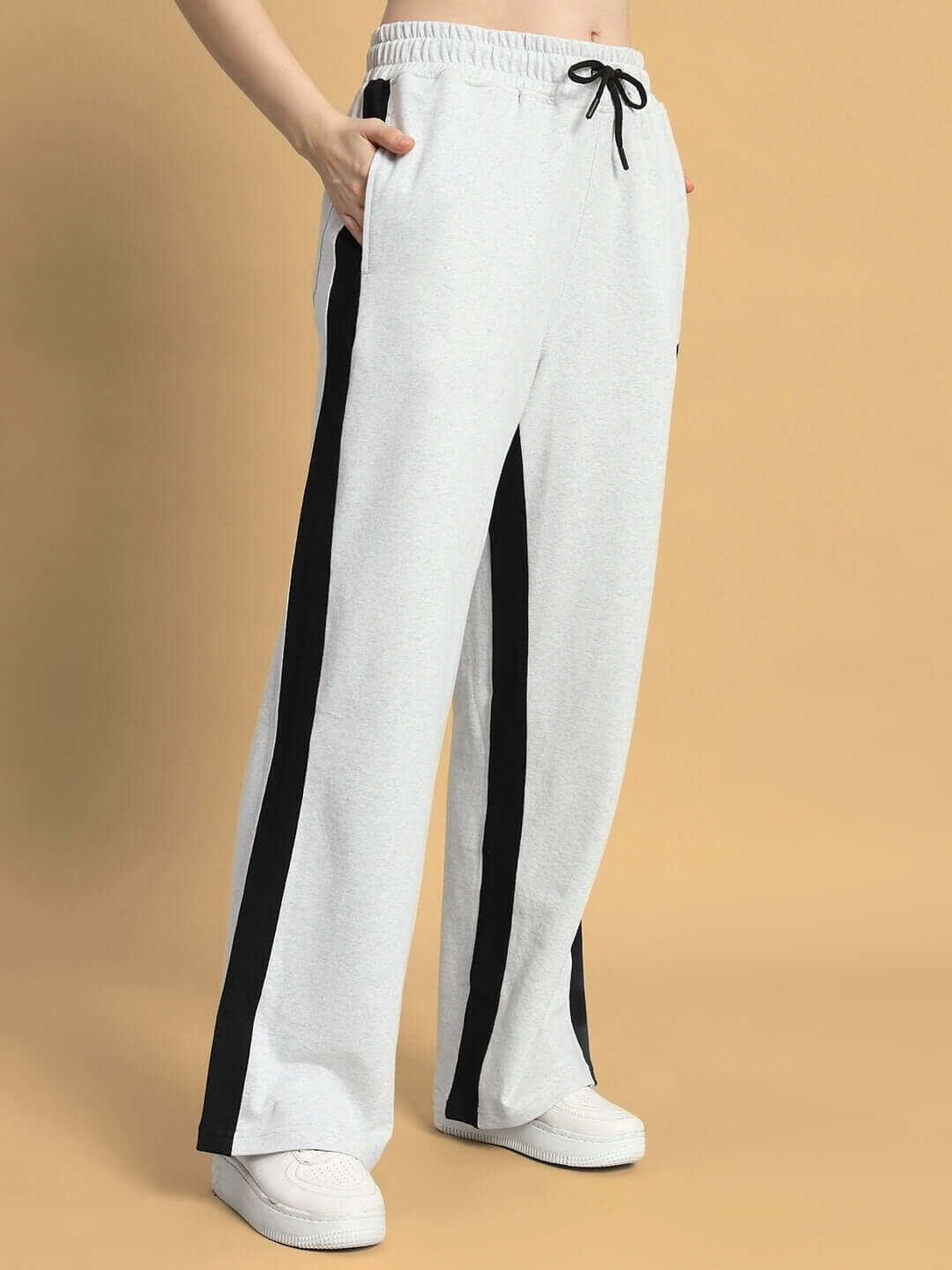 Model wearing women's grey-black baggy joggers with side seam and drawstring waist, showcasing comfort and style by DUDS.