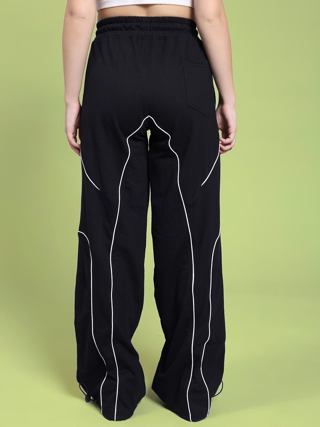 Back view of WOMEN SIGNATURE PIPING JOGGERS BLACK showcasing contrast piping detail for a stylish and modern look.