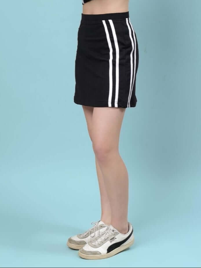 Side view of a model wearing a Women's Simone Designer Black Skirt with sporty white stripes, ideal for custom fit.