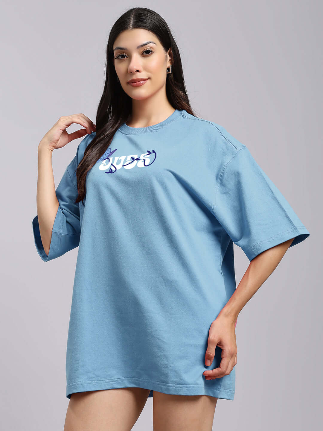Woman wearing sky blue women's printed t-shirt made of premium cotton fabric, featuring a comfortable fit and stylish design.