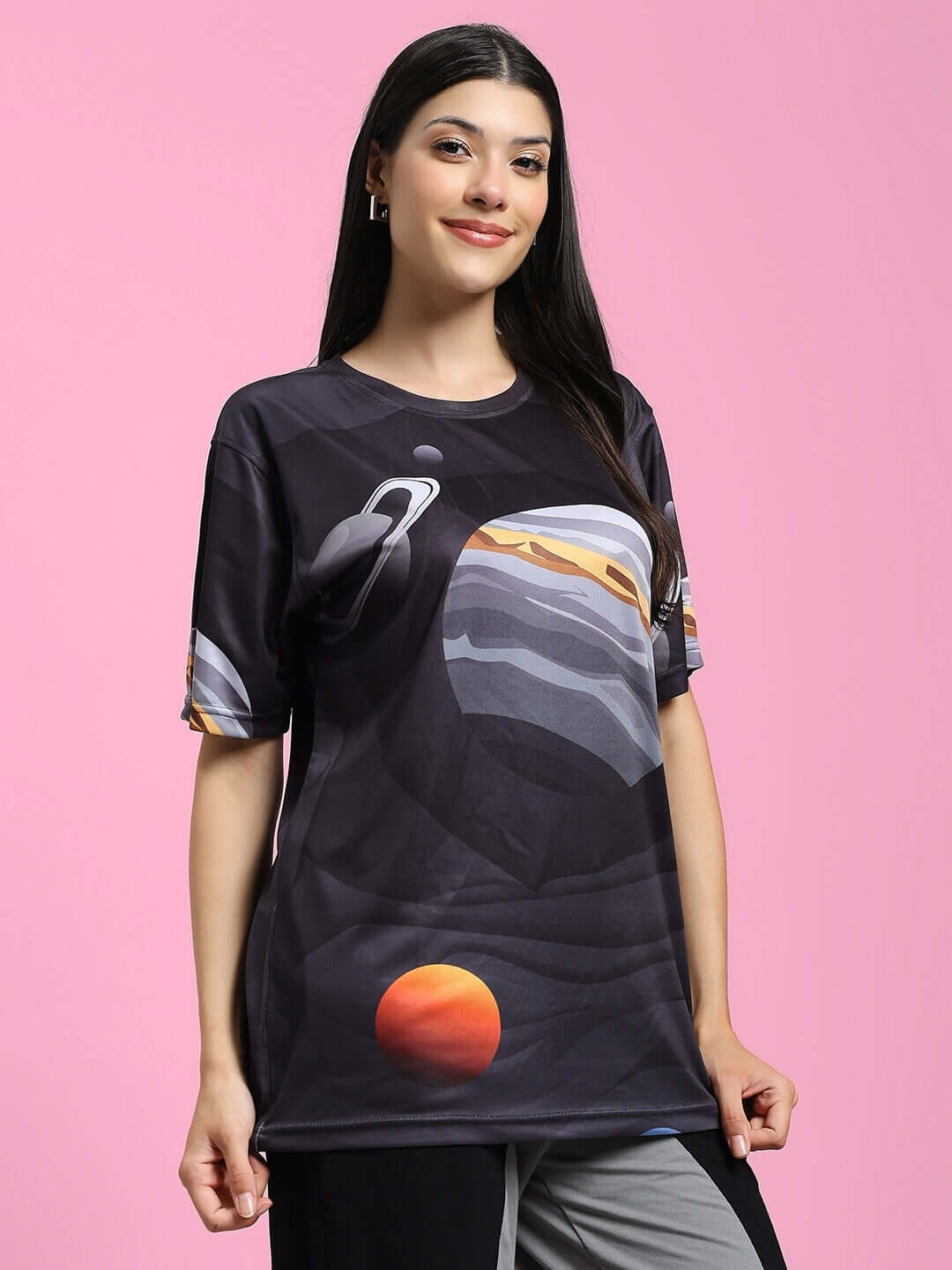 Woman wearing a Women's Space Fantasy printed black T-shirt made of polyester fabric, featuring an astronaut and planet design.