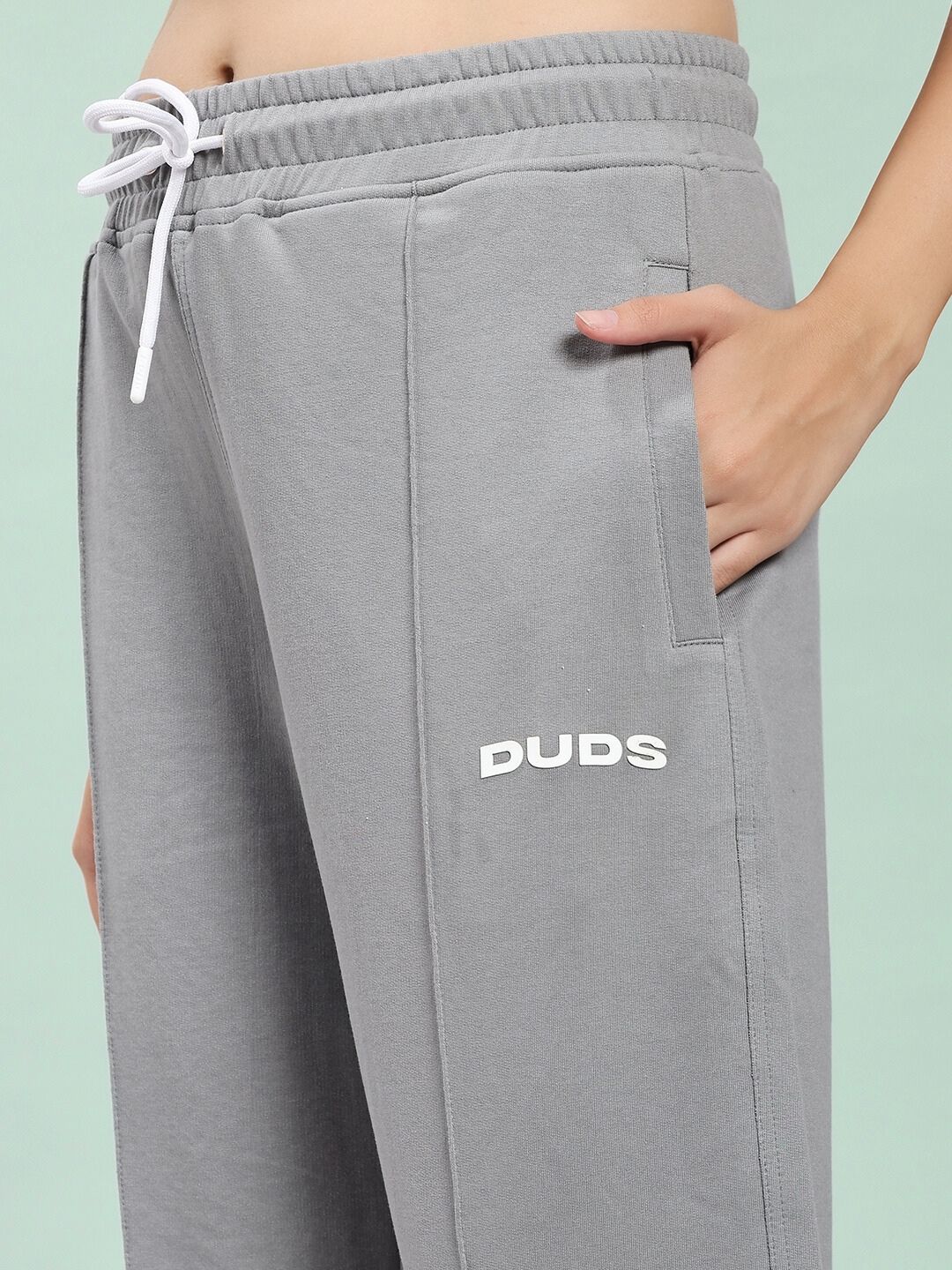 Close-up of WOMEN SPIRAL RELAXED-FIT JOGGERS GREY with hand in pocket, showcasing the soft cotton-blend fabric design.