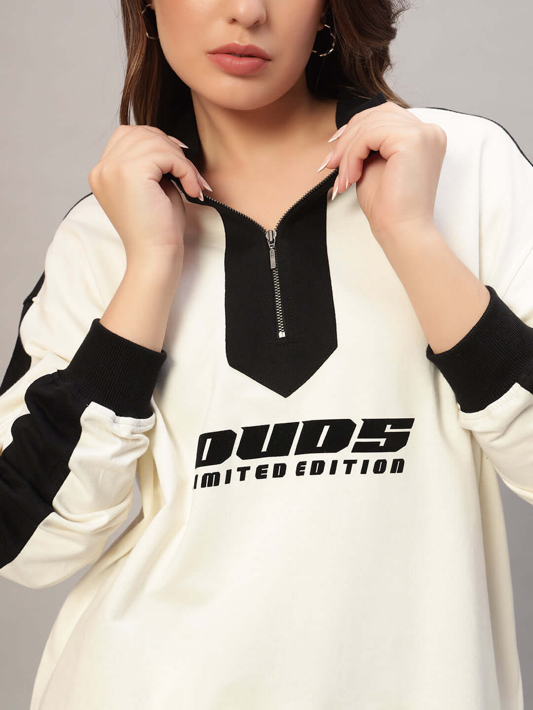 Woman wearing WOMEN SPLINTER OVERSIZED CO-ORD SET OFF WHITE BLACK with bold lettering and zipper detail.