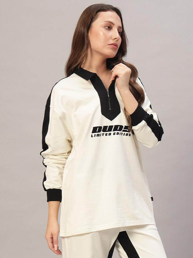 Woman wearing oversized off-white sweatshirt with black accents, featuring "Dude's Limited Edition" text. Premium cotton French terry fabric.