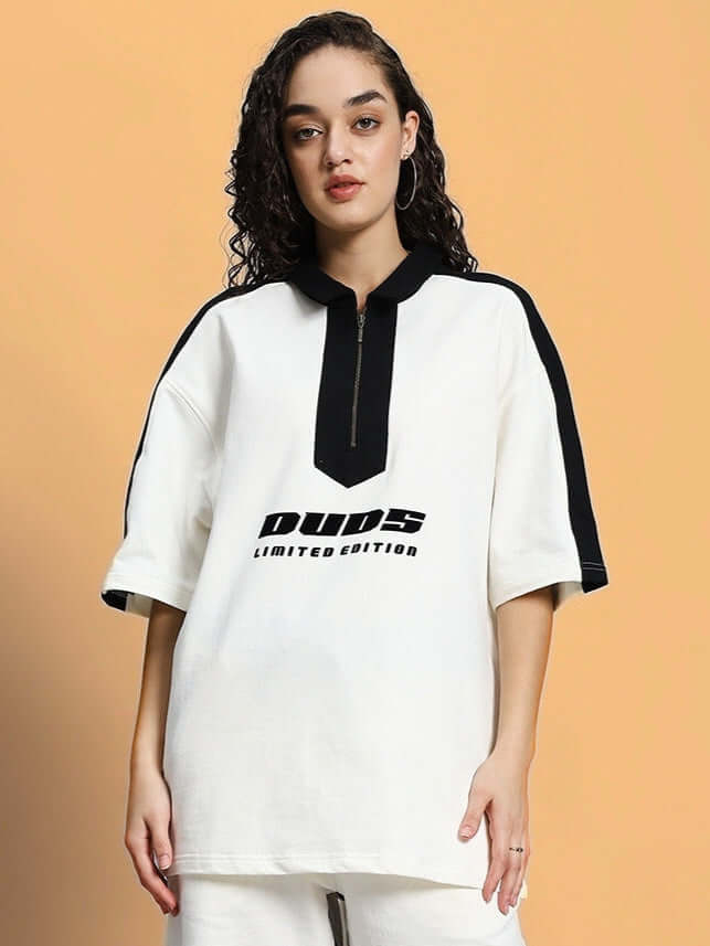 Model wearing women's oversized off-white t-shirt, premium cotton French terry, featuring a stylish limited edition logo design.