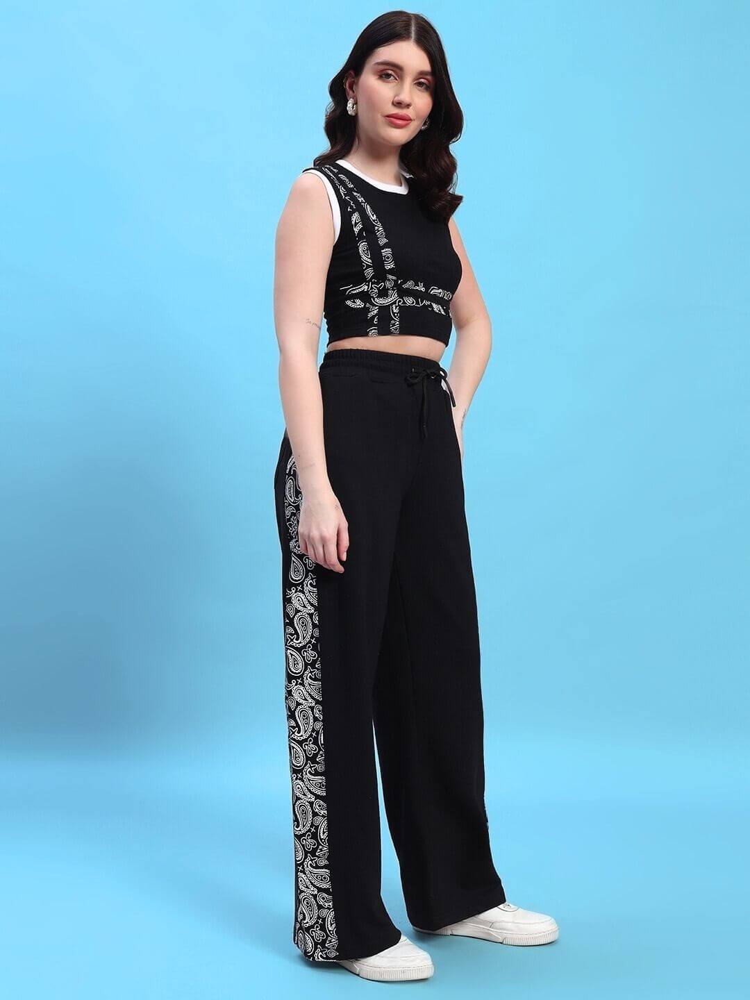 Model wearing WOMEN'S SQUARO DESIGNER CO-ORD SET BLACK against blue background