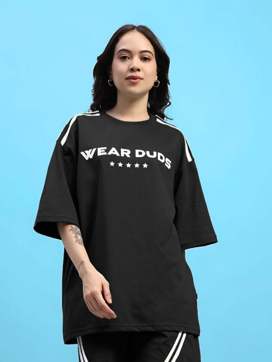 Model wearing black oversized Women's Star Jumper T-Shirt made from premium cotton fabric, featuring white text and star design.