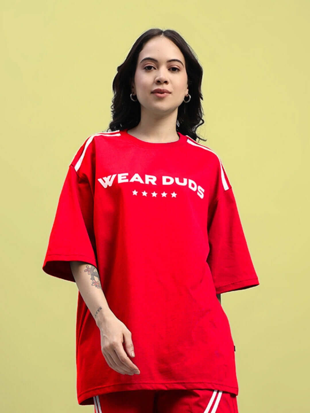 Model wearing women's oversized red star jumper T-shirt made from premium heavy gauge fabric.
