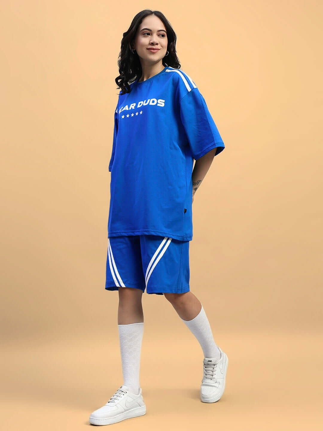 Woman wearing blue Women's Star Jumper Summer Co-Ord Set, made of cotton terry lycra, perfect for casual summer style.