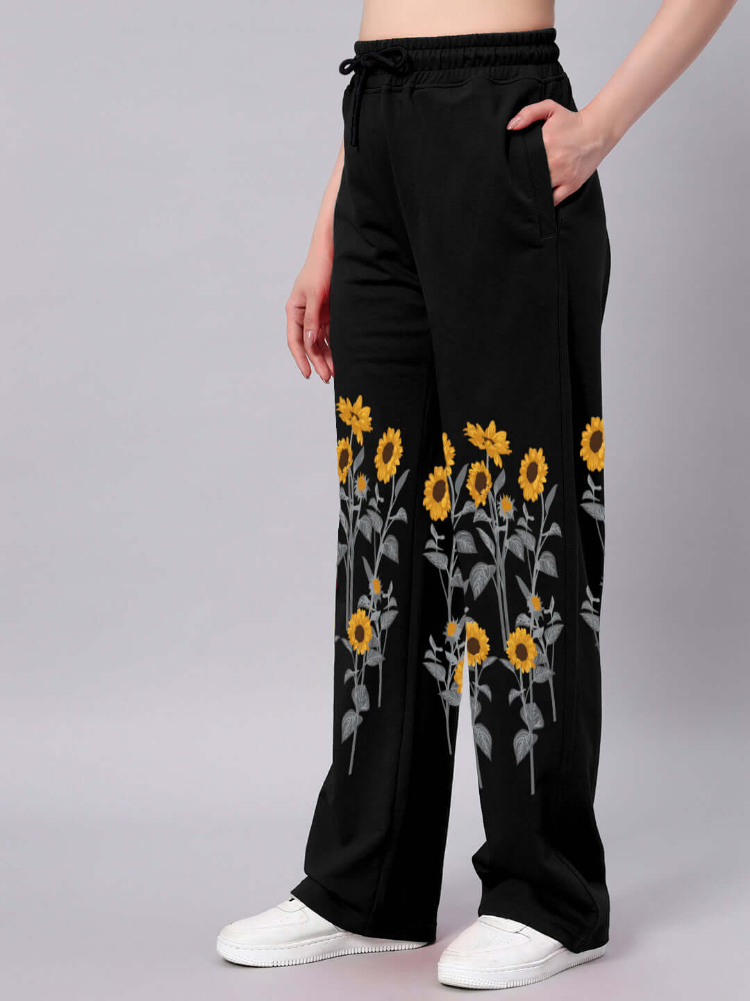 Women's black jogger pants with sunflower print, relaxed fit, customized options, made by DUDS, comfortable and stylish design.