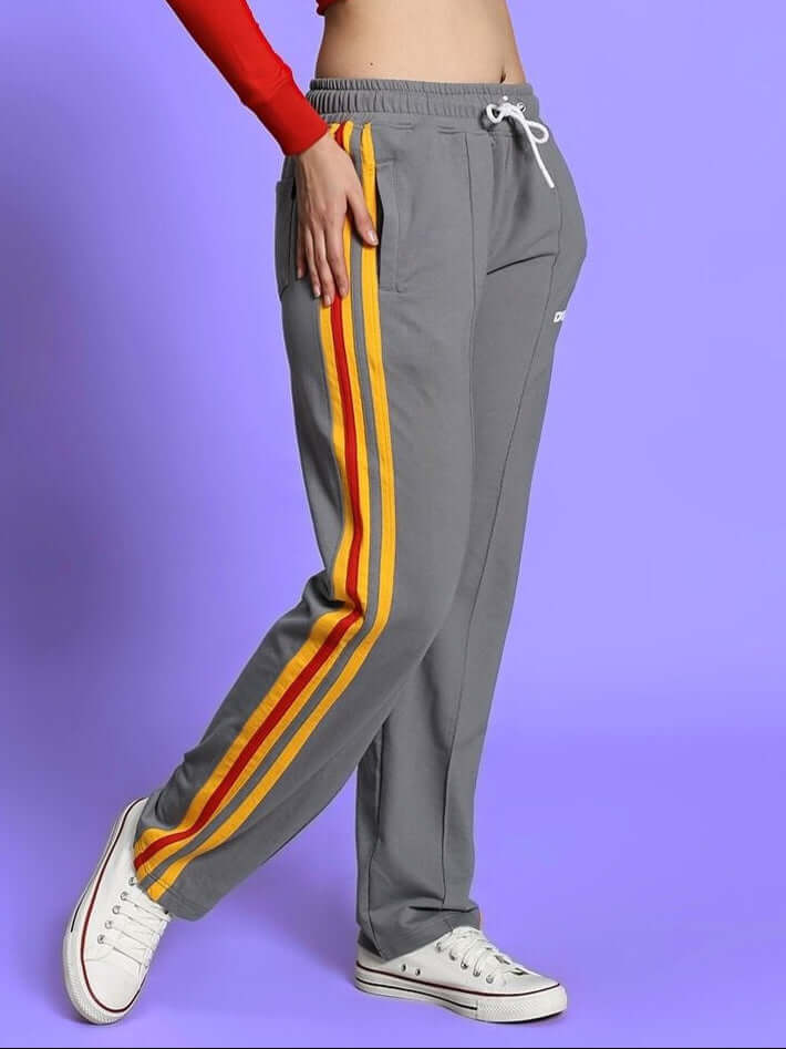 Women's grey jogger pants with sunshine stripe design, customizable fit, handmade by DUDS tailors, shown worn with white sneakers.