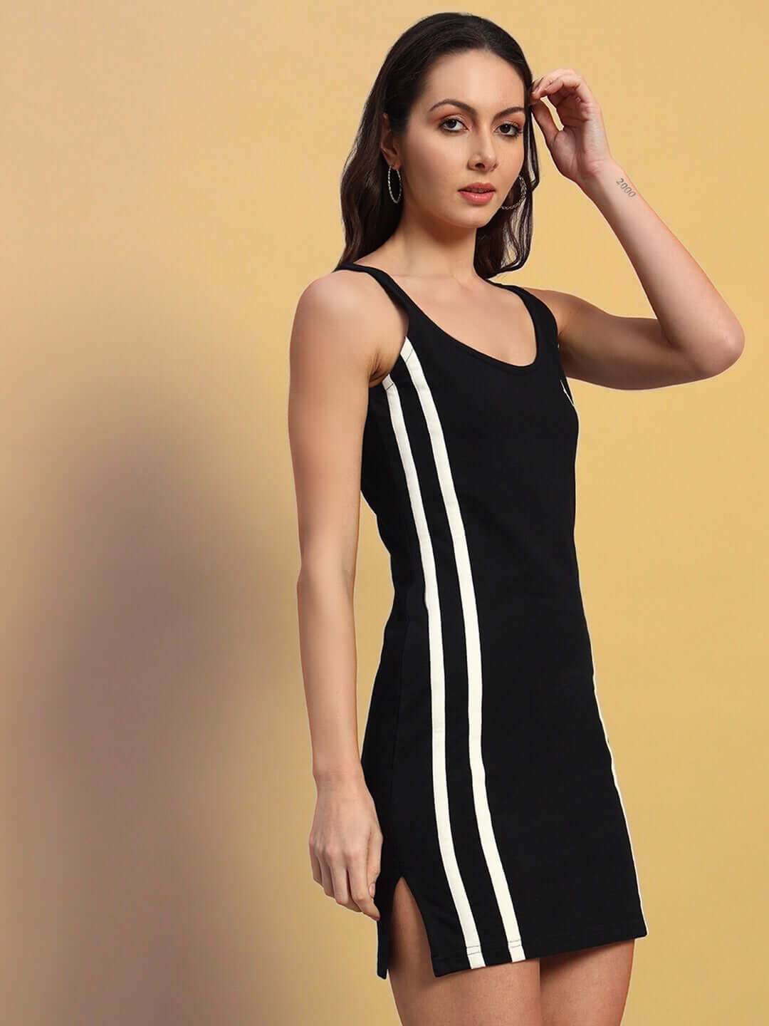 Woman modeling black Women's Supremacy Dress, featuring white stripes and made of polyester and spandex blend. Fashionable and stylish.