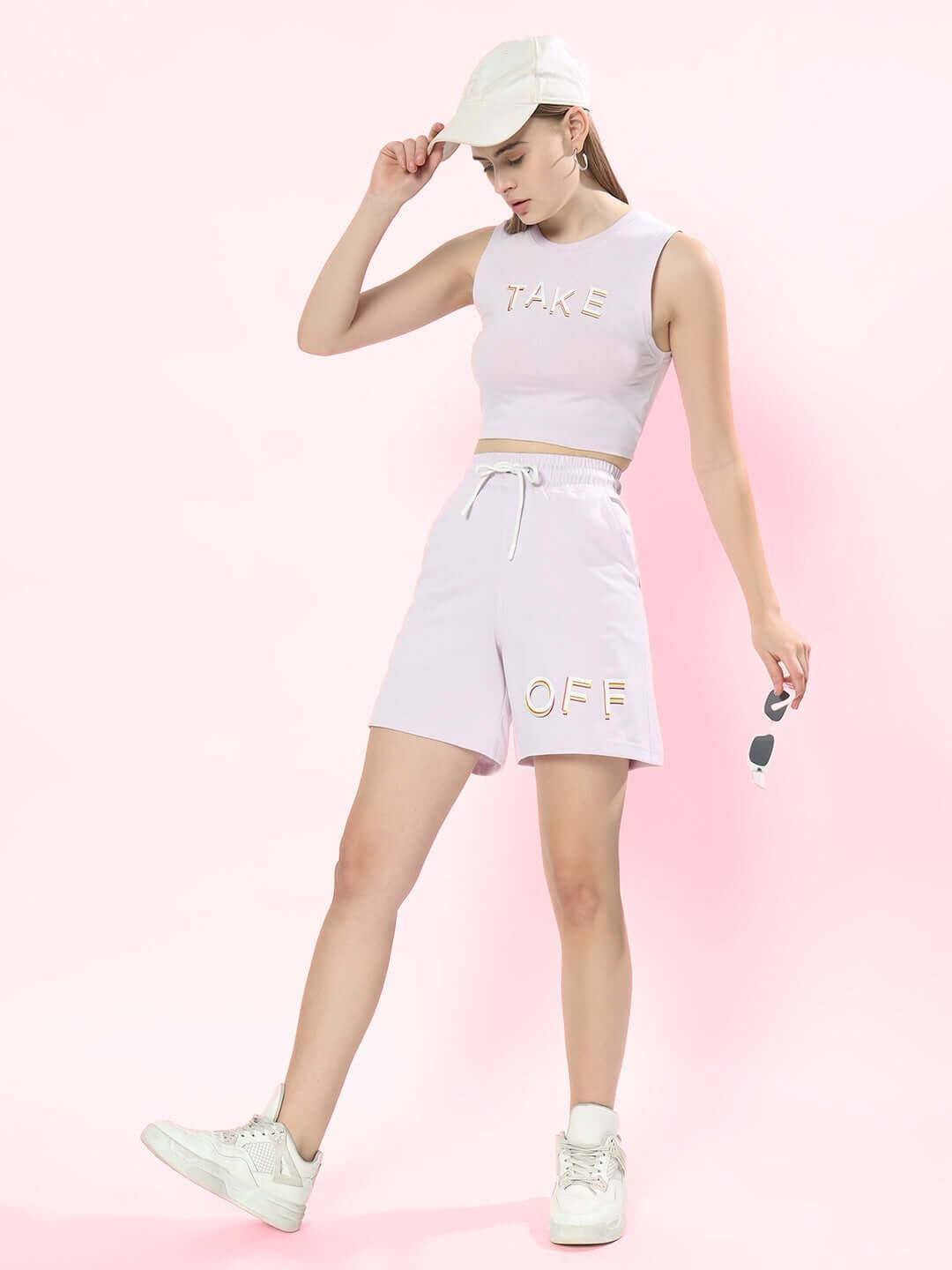 Model wearing lilac women's co-ord set, featuring crop top and shorts with 'TAKE OFF' print. Premium cotton blend, perfect for casual style.