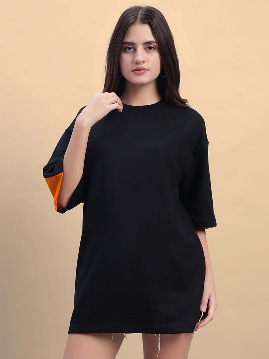Women's Titan oversized T-shirt in black and orange, made from premium French terry cotton, displayed on a model against a neutral background.
