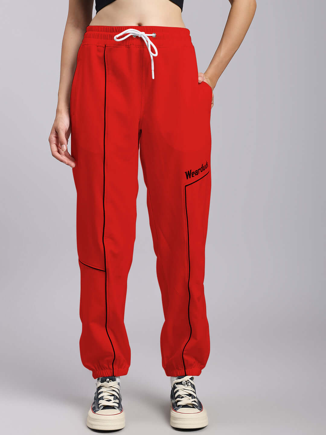 Women's relaxed fit red joggers with drawstring, modeled, showcasing casual style and custom fit option.
