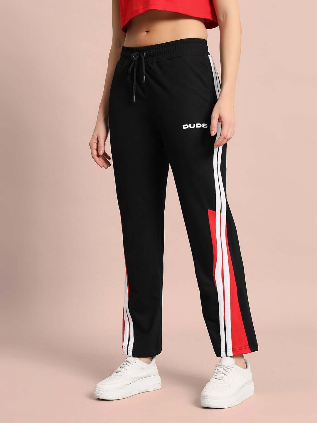 Model wearing Women's Tornado Joggers in black and red by DUDS, featuring customizable sizes, made-to-order with premium tailoring.