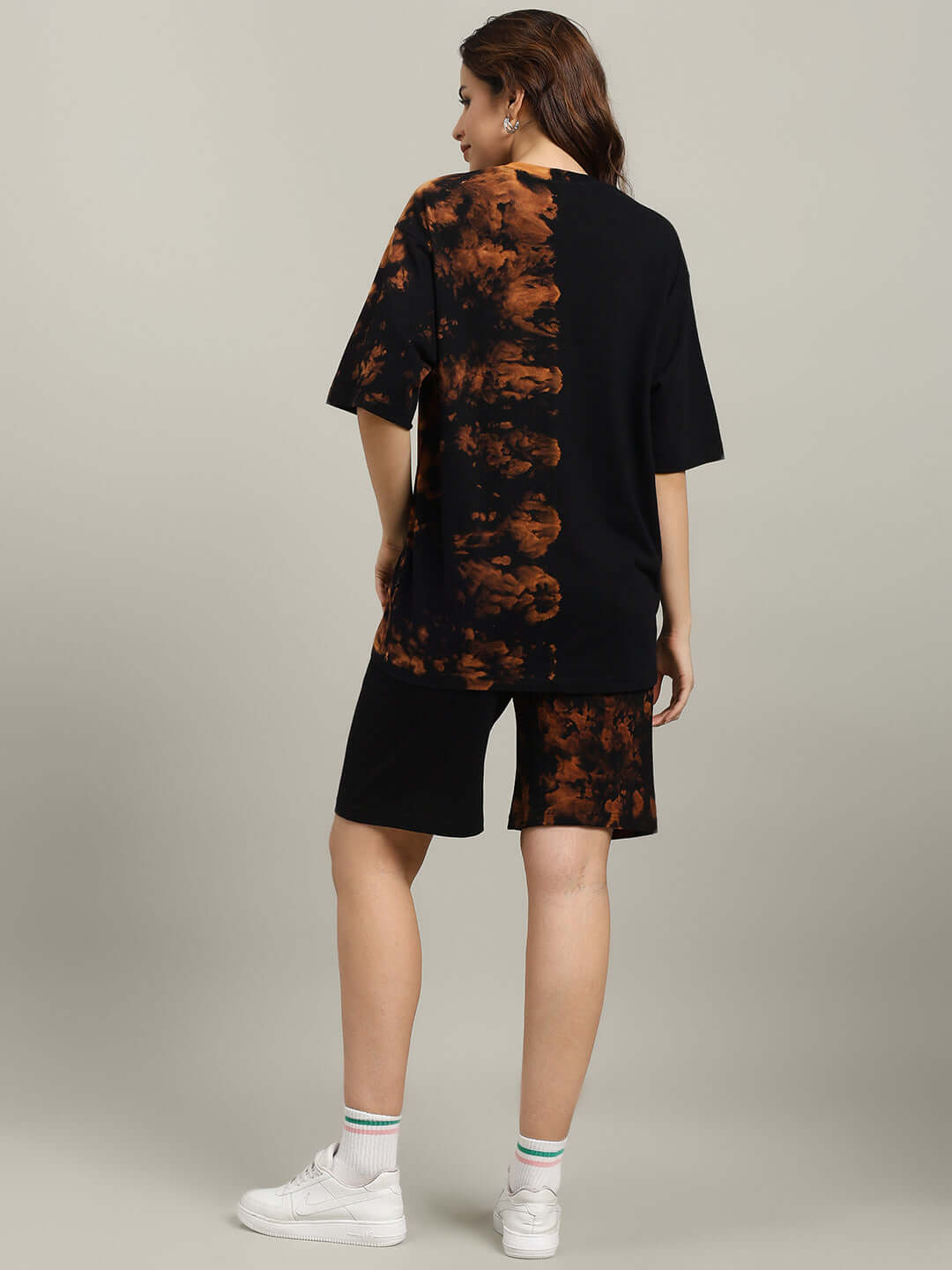 Model wearing WOMEN'S TRICKSTER TIE-DYE CO-ORD SET BLACK, featuring a stylish black and tie-dye pattern, back view.