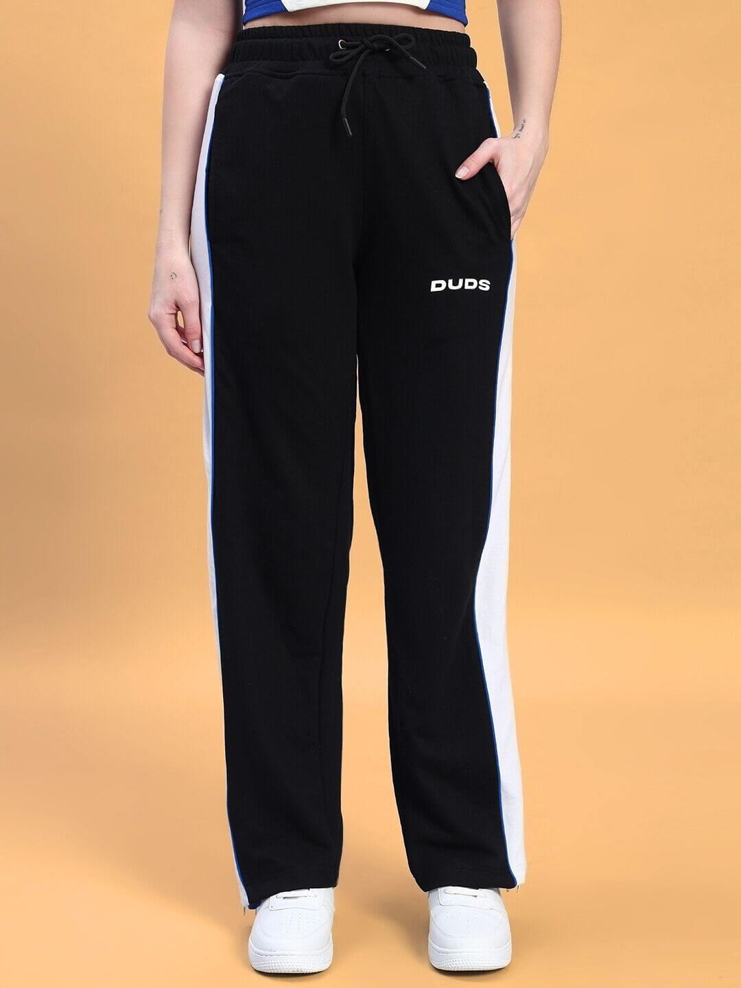 Women's Triumph Multi Zipper Joggers in Black and Blue by DUDS, front view showing sporty design and side stripes.