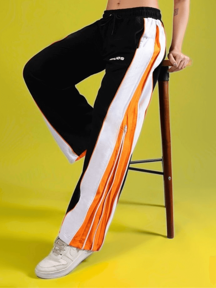 WOMEN'S TRIUMPH Multi Zipper Joggers in Black and Orange with customizable fit by DUDS, featuring sleek design and vibrant stripes.