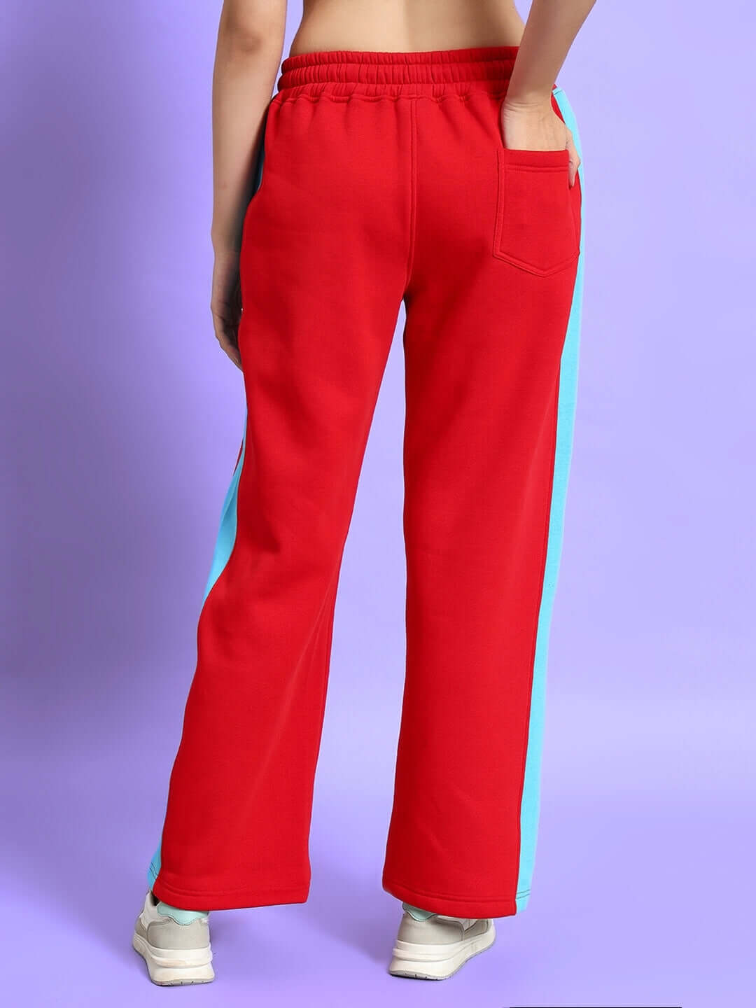 Back view of WOMEN TRUNKIT FLEECE COLORBLOCK CARGO PANT in red and blue, featuring roomy cargo pockets and relaxed fit for modern style.
