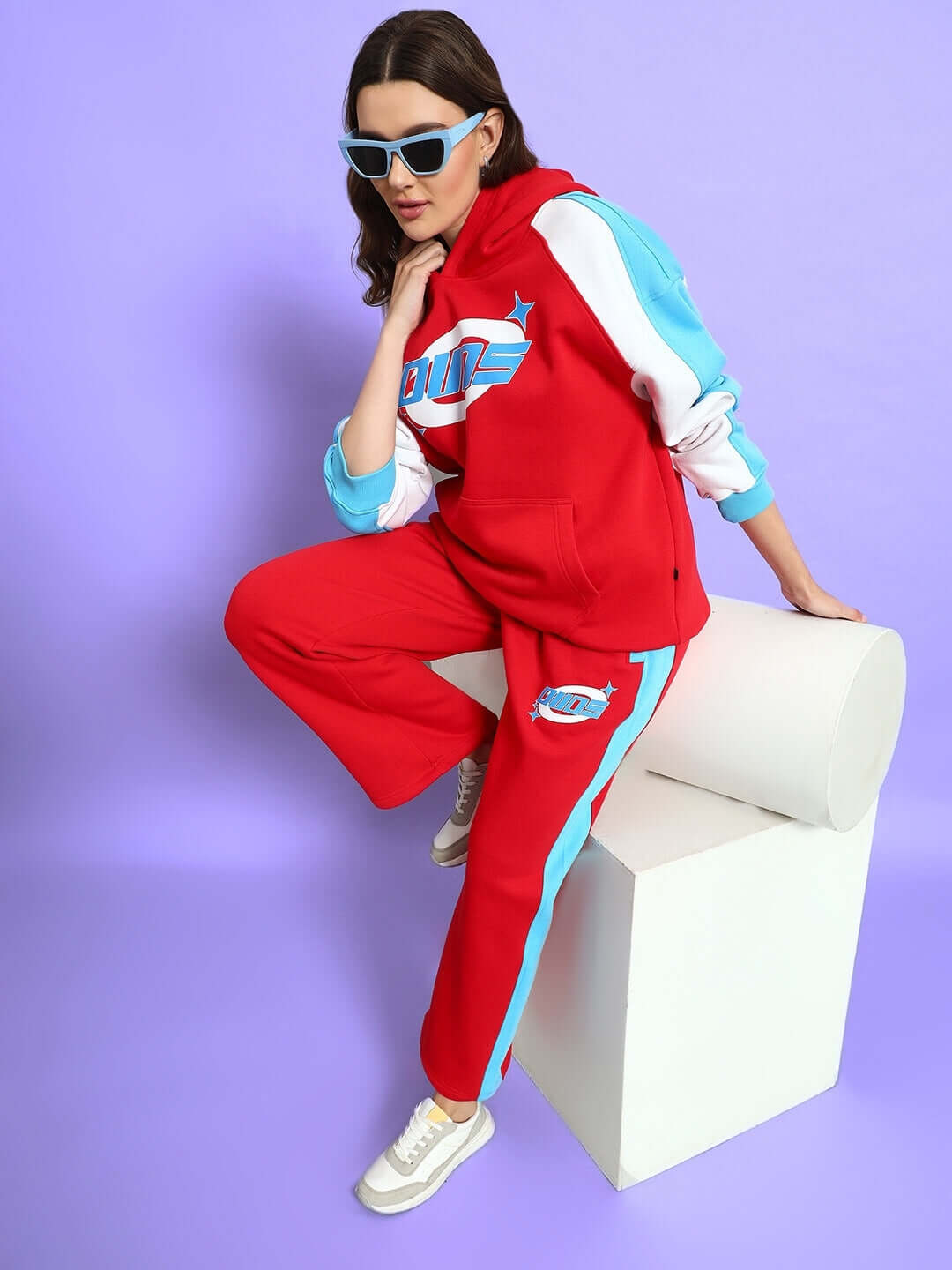 Model wearing Women's Trunkit Colorblock Co-ord in red with blue and white accents, styled with sunglasses, from DUDS fashion.