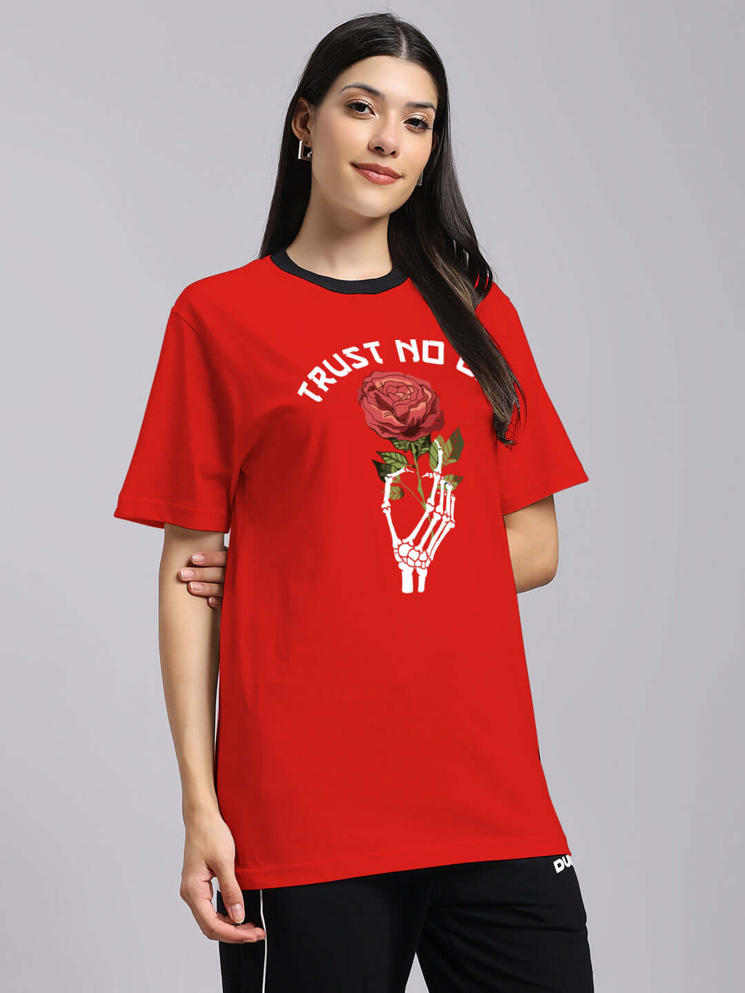Woman wearing red 'Trust No One' printed t-shirt with rose design, regular fit. Premium 100% cotton fabric, cold machine wash recommended.