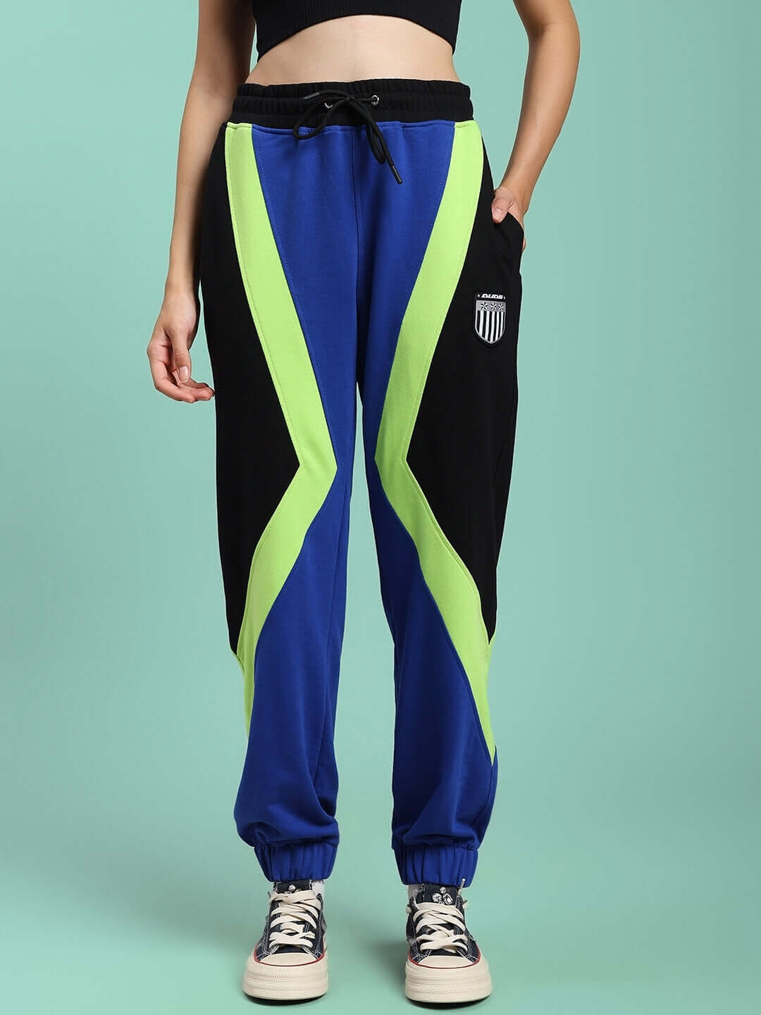 Women's ultra colorblock relaxed-fit joggers in blue-black, side pockets, worn by model, featuring a vibrant design by DUDS.