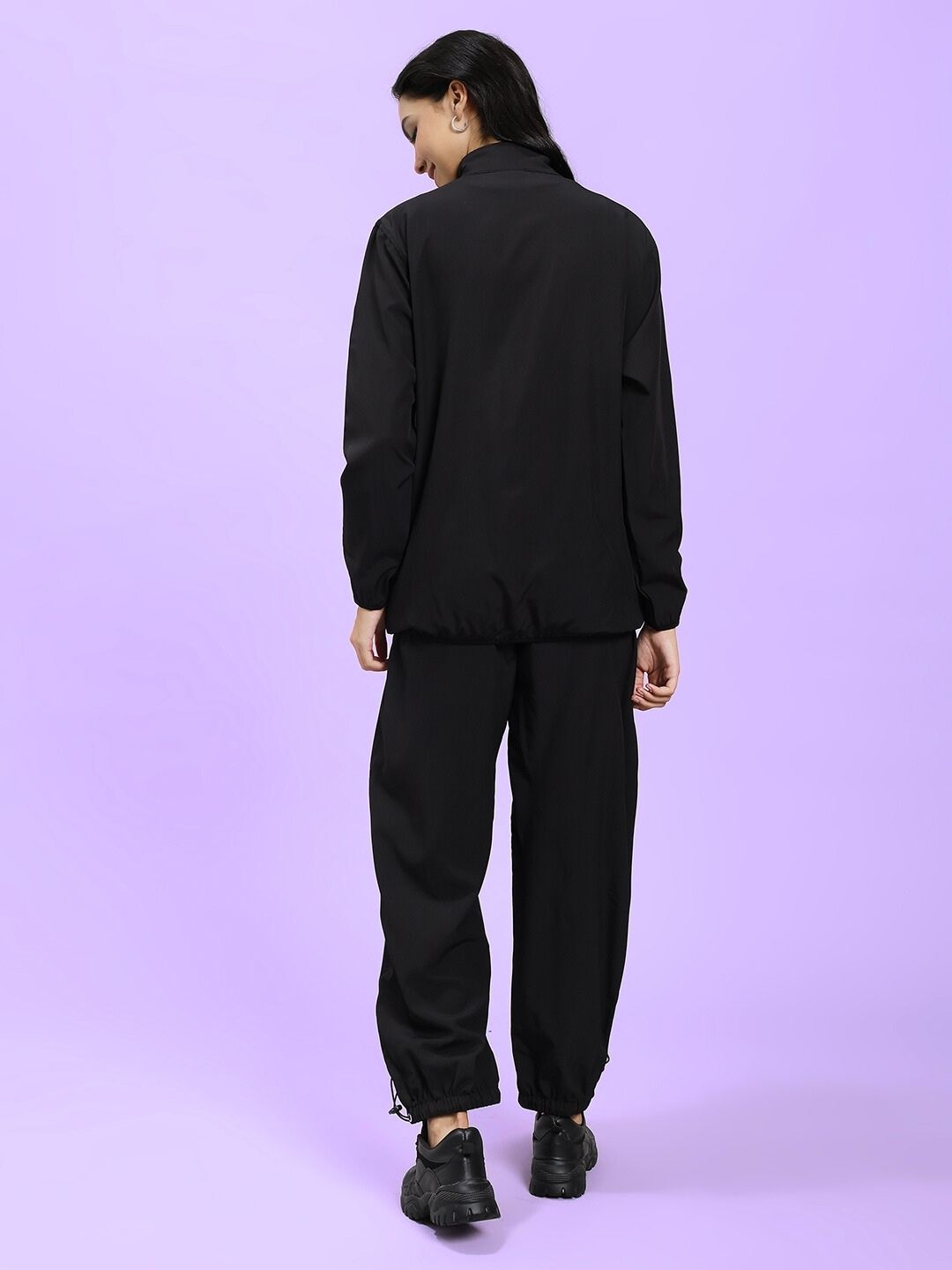 Back view of model wearing WOMEN UNISON RELAXED FIT CO-ORD SET BLACK RED, showcasing the stylish ensemble in casual wear.