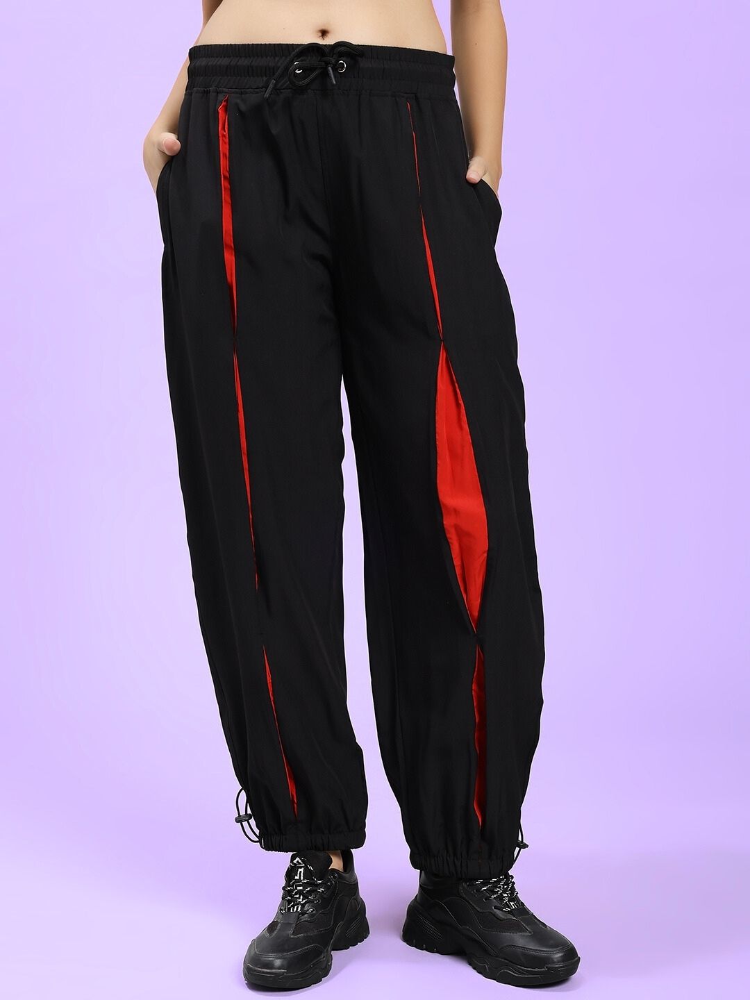 Alt Tag: WOMEN'S UNISON RELAXED-FIT JOGGERS BLACK RED, comfortable joggers for kids in black with red accents on a light purple background.