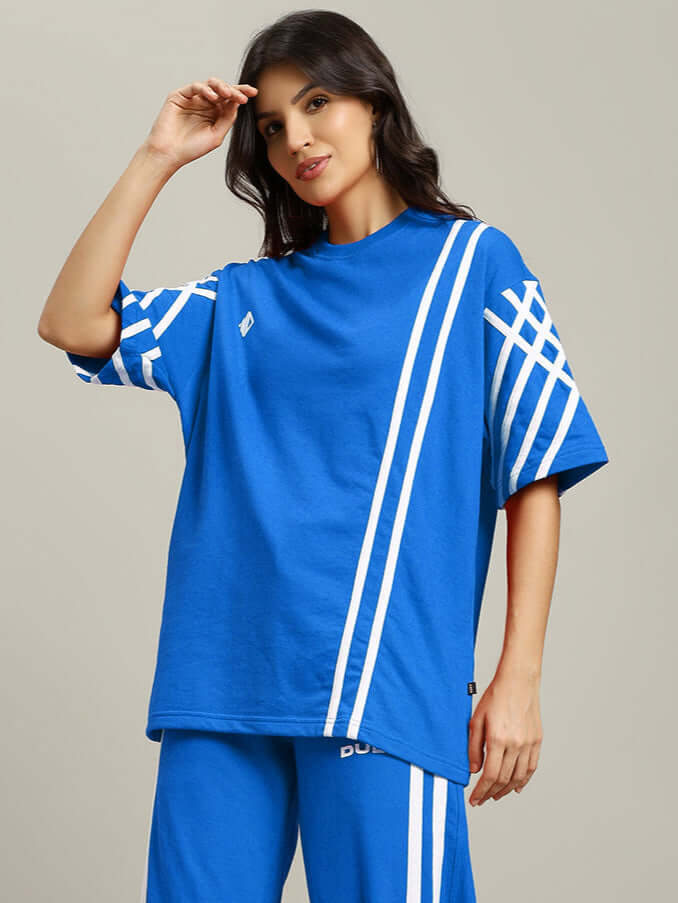 Women's blue oversized T-shirt with white stripes, made of premium cotton French terry fabric, styled casually by a woman.