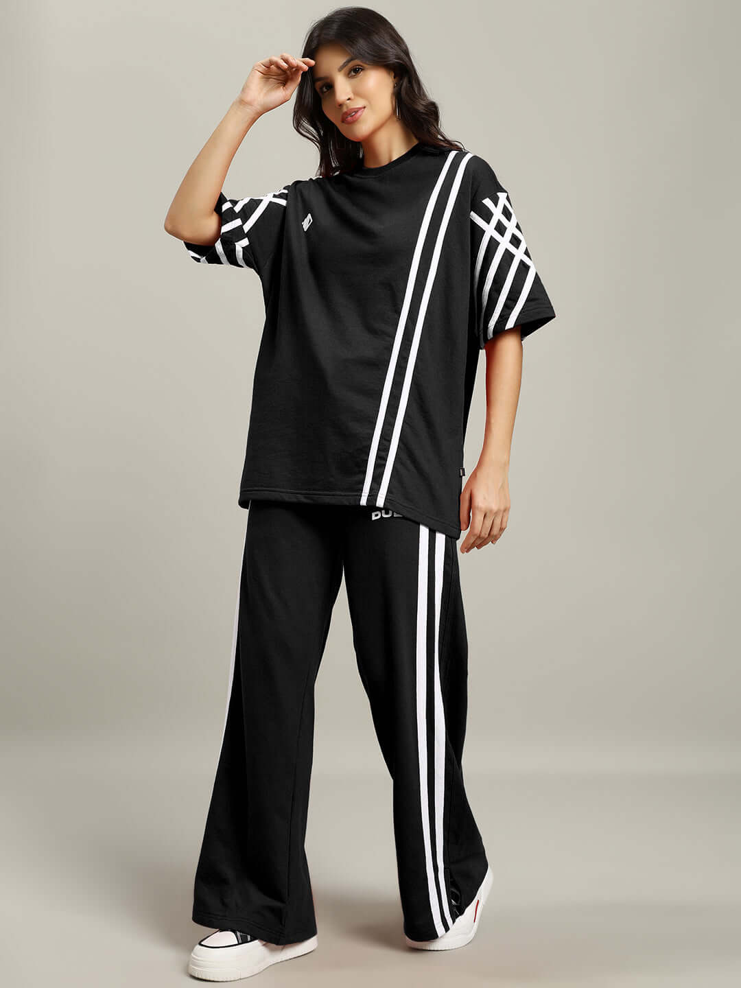 Model wearing Women's United Stripe Co-Ord Set in black with white stripes, made from premium cotton French terry lycra fabric.