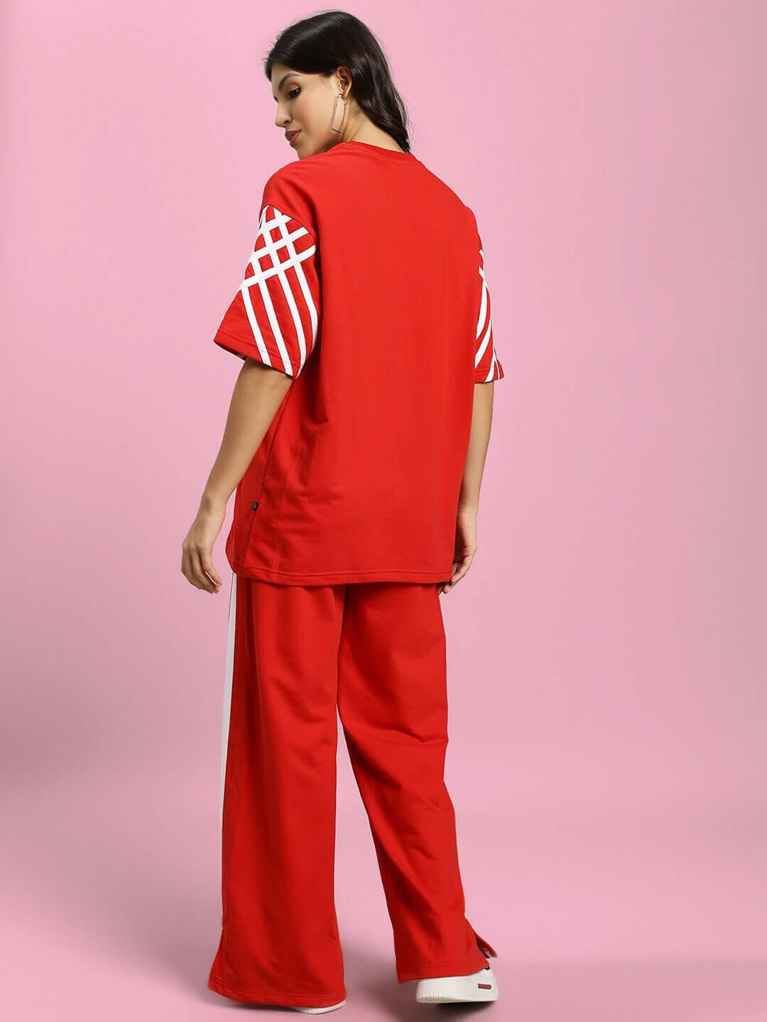 Red Women's United Stripe Co-Ord Set with geometric sleeves, made from premium cotton blend, displayed on a model against a pink backdrop.