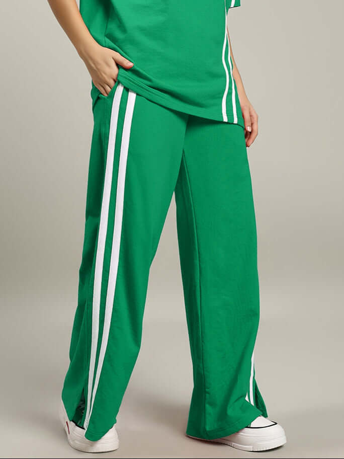 Green women's joggers with white stripes, modern casual wear for active lifestyle. Versatile and stylish fashion by DUDS.