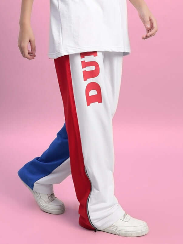 Model wearing Women's Urban Drift Relaxed Fit Joggers in white, red, and blue on pink background, showcasing multi-color design.
