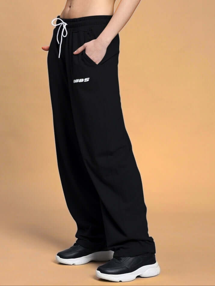Model wearing black women's vanilla relaxed-fit joggers by DUDS, showcasing comfortable style and custom-fit option availability.