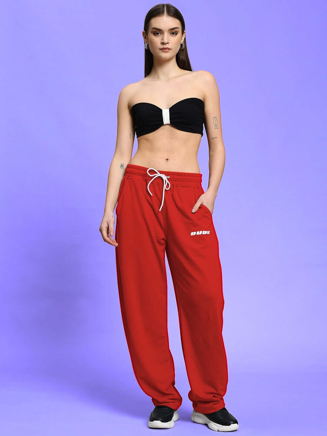 Model wearing Women's Vanilla Relaxed-Fit Joggers in red, showcasing casual style with a custom fit option from DUDS.