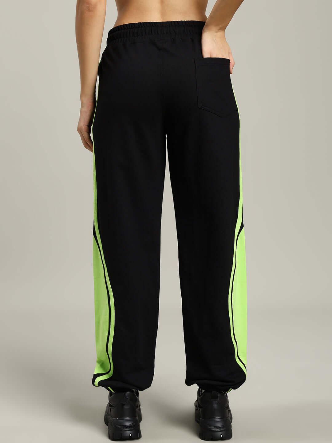 Back view of Women's Vector Baggy Joggers in black with neon stripes.