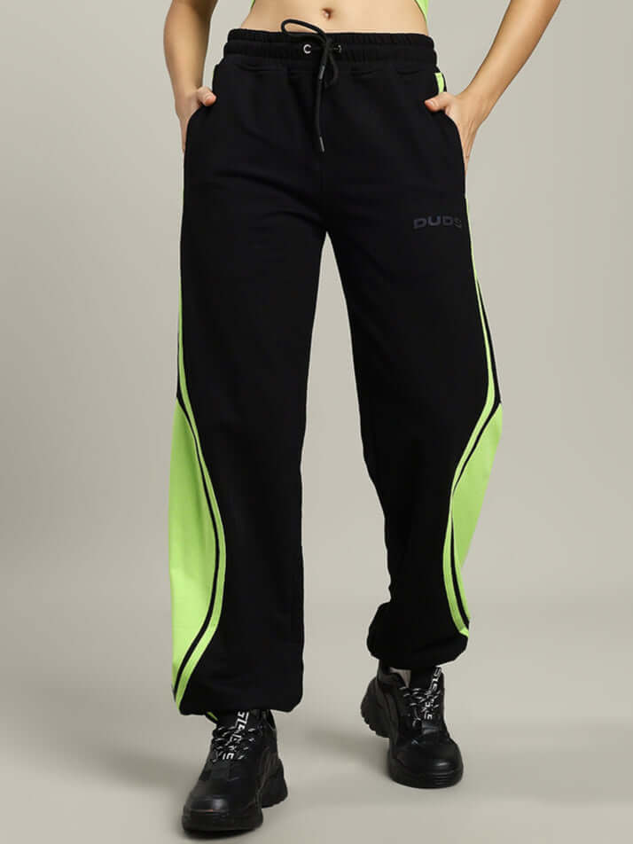 Woman wearing black-neon Women's Vector Baggy Joggers, showcasing comfortable fit and style, made by DUDS, perfect for custom orders.