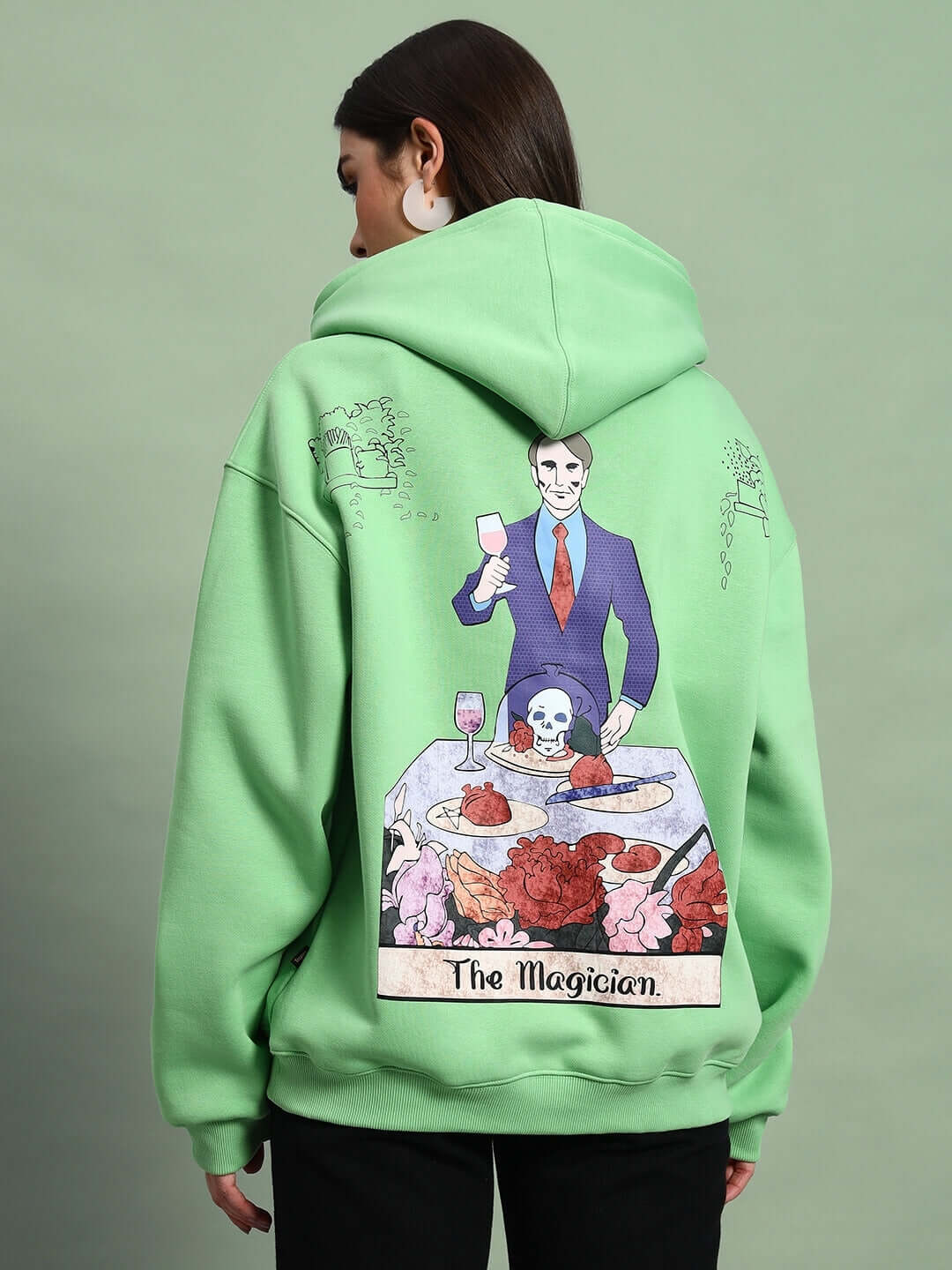 Back of WOMEN VOODO FLEECE OVERSIZED HOODIE GREEN with The Magician graphic, showcasing bold streetwear style.