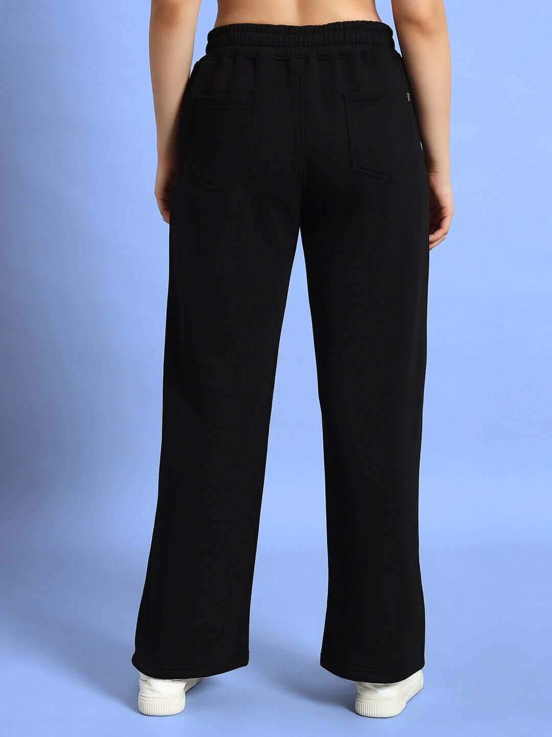 Back view of WOMEN WD ADMIRE FLEECE CARGO PANT BLACK showcasing sleek design and pocket details for streetwear style.