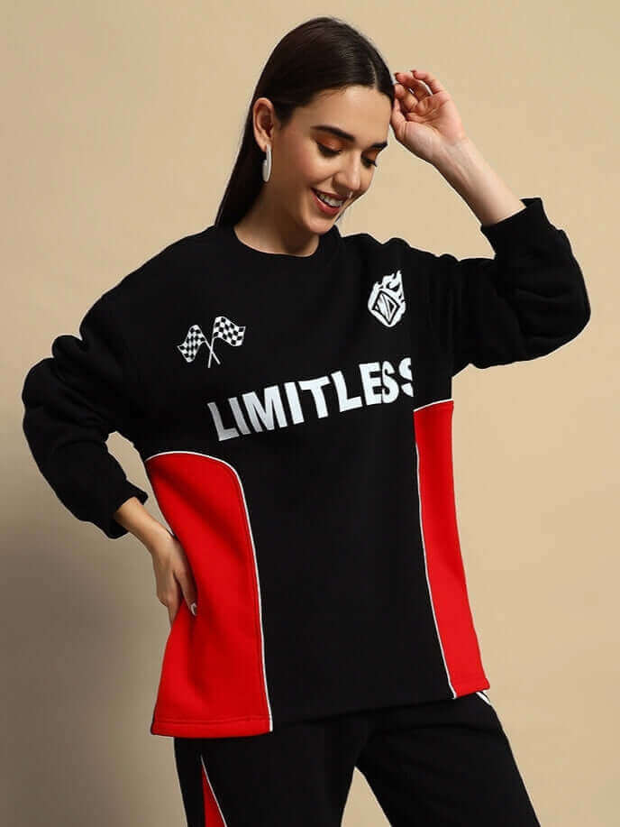 Woman in black and red colorblock co-ord with 'Limitless' print, emphasizing bold streetwear style and comfort.