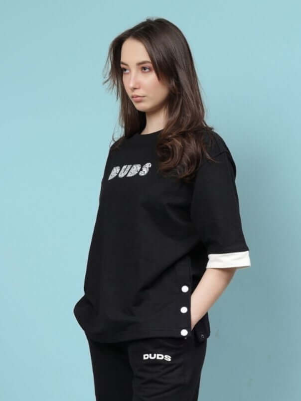 Woman wearing a black oversized women's Wesent T-shirt featuring premium cotton fleece, suitable for casual wear.