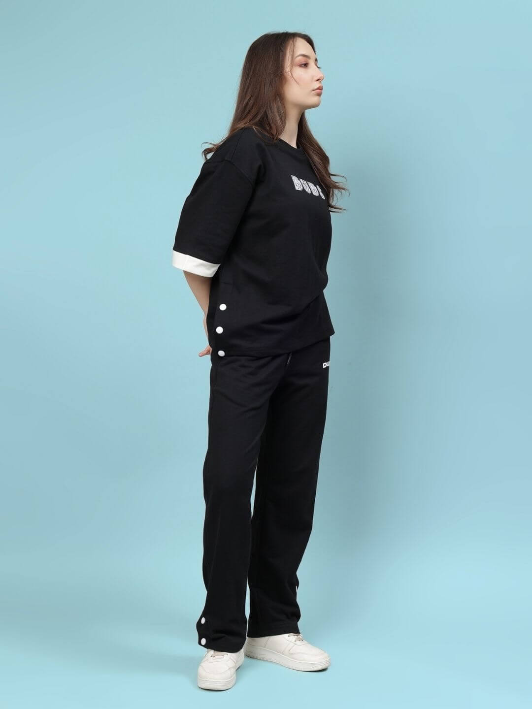 Model wearing WOMEN'S WESENT RELAXED-FIT CO-ORD SET BLACK made of premium cotton and elastane blend, stylish and casual outfit.