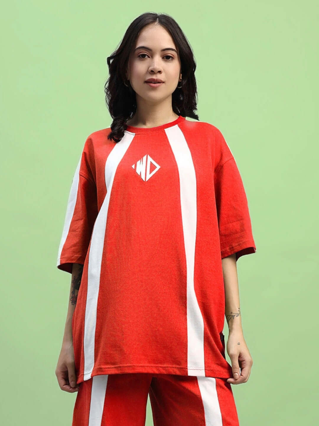 Model wearing a red women's wideline oversized t-shirt made of premium cotton fabric, featuring a stylish design. Made in India.
