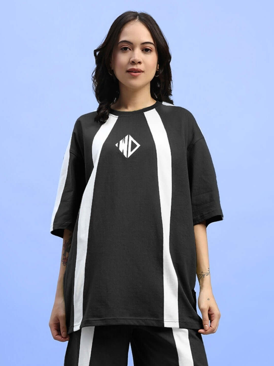 Model wearing women's oversized black wideline t-shirt by Color By Colours, featuring premium cotton blend and stylish casual design.
