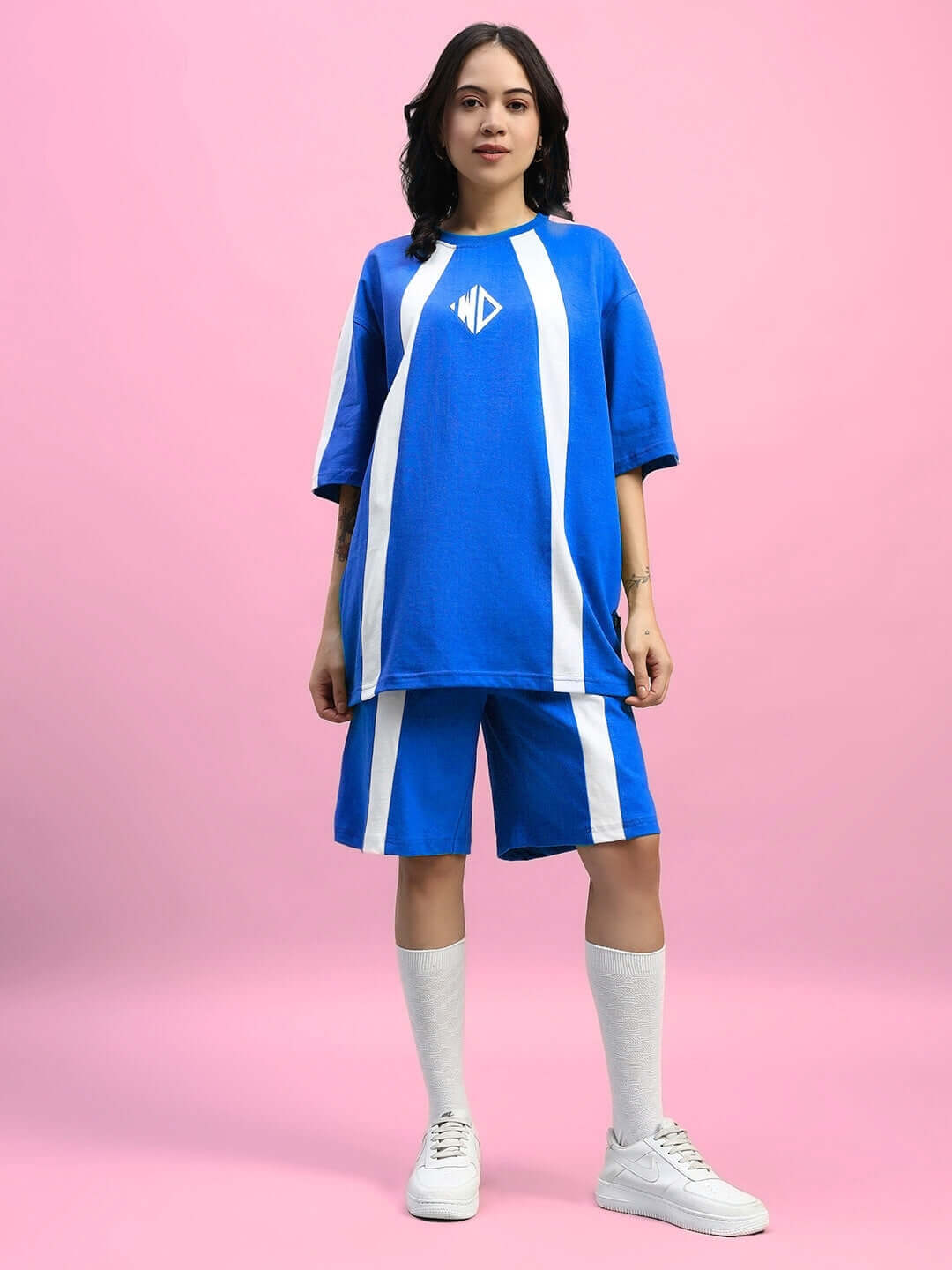 Woman wearing blue summer co-ord set with white stripes, featuring premium cotton and elastane fabric, ideal for casual wear.