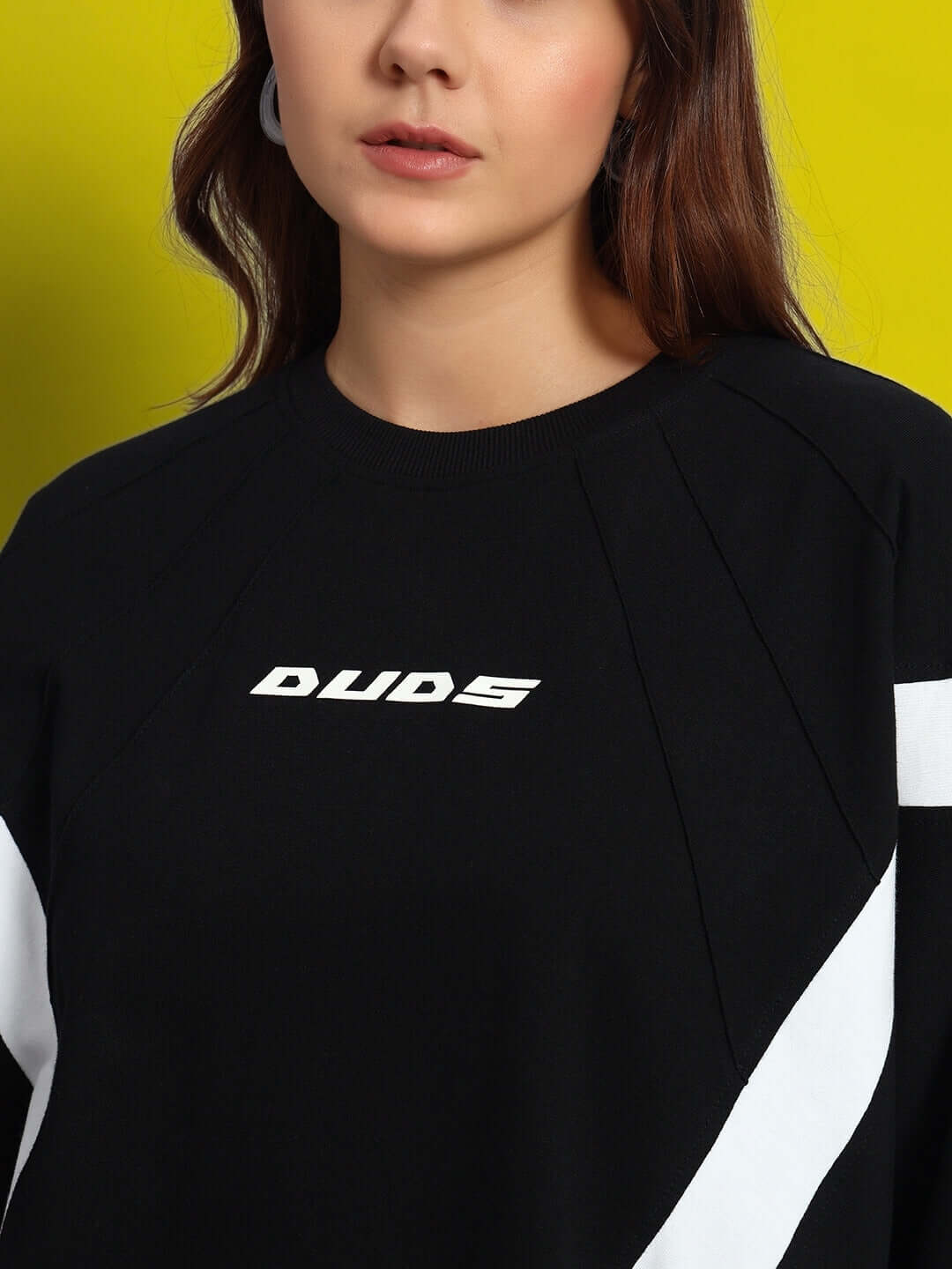 Front view of Women's Wild Force oversized black and white T-shirt made from premium cotton blend, featuring logo detail.