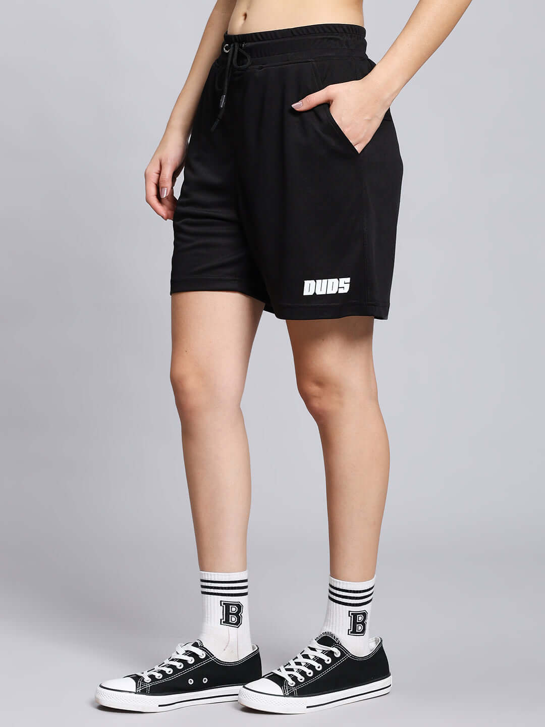 Model wearing Women's Wily Tactical Regular Fit Shorts in black, featuring a comfortable elastic waist and stylish logo detail.