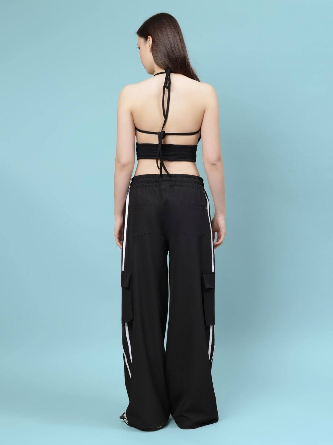 Back view of model wearing WOMEN'S XAVIER CO-ORD SET BLACK, showcasing the stylish design of WEAR DUDS' streetwear outfit.